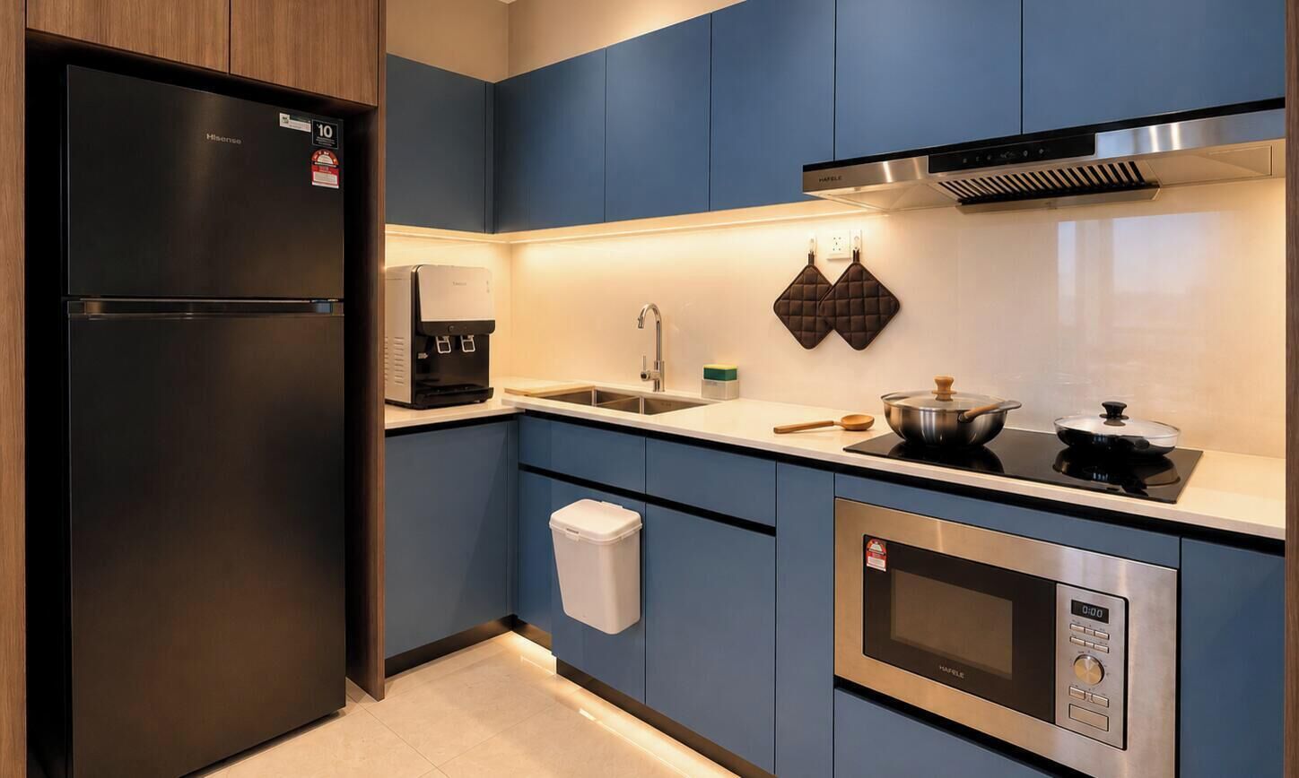 A modern kitchen with a built-in refrigerator, coffee machine, microwave, and stove.