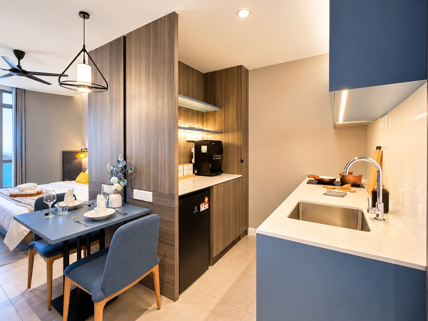 A modern kitchen with a built-in dishwasher, a dining area with a table and chairs, and a ceiling fan.