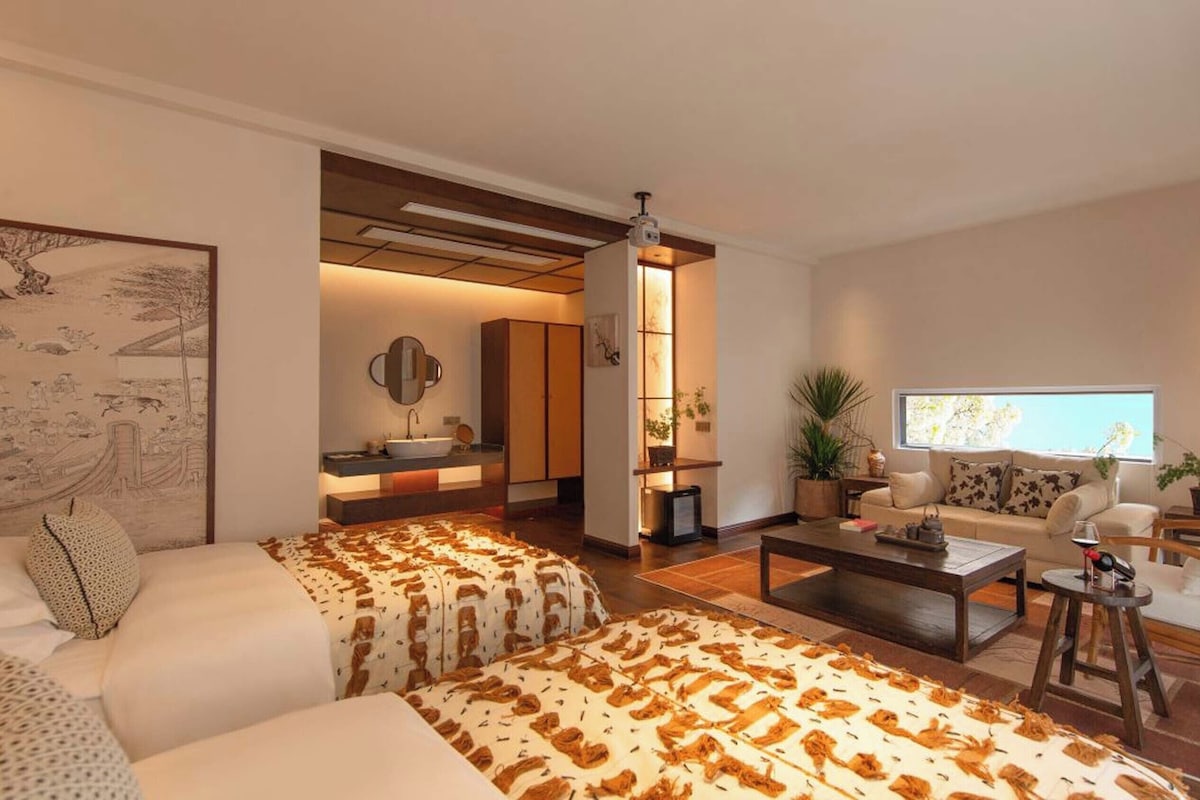A modern living room with a sofa, coffee table, and a television.