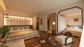 A hotel room with two beds, a large mirror, a coffee table, and a small side table. - Yunye Fengwan Song's Aesthetic Hotel (Deqin)