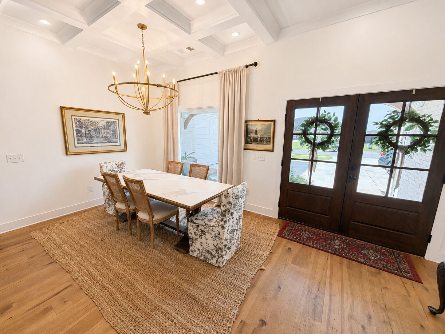 A dining area with a table, chairs, and a chandelier.