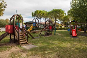 A playground with various play structures including slides and climbing areas. - Mobile home with air conditioning and parking (Sirmione)