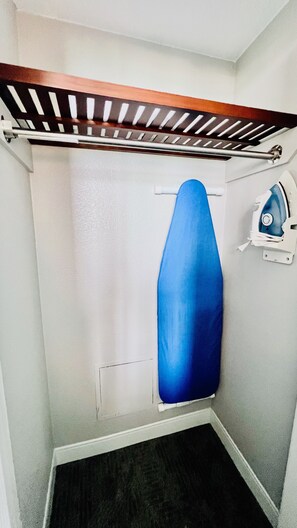 A small bathroom with a shower, a towel rack, and a wall-mounted iron. - Fully Renovated Direct Oceanfront Corner Unit Perfect for Family Gateway (Myrtle Beach)
