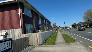 A building with a sign for 'AWA HOTEL' and a sign for 'Industrial & Industrial.'
