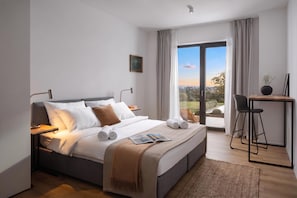 A modern hotel room with a large bed, a desk, and a view of the outdoors. - Villa Sealine - Pool & Garden, Pula, Croatia (Pula)
