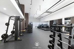 A modern gym with various exercise equipment, including weight machines and treadmills. - Miami Luxury Studio Rooftop Resort Style (Miami)