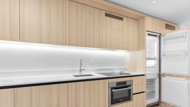 A modern kitchen with wooden cabinets, a stainless steel sink, a Bosch oven, and a Bosch refrigerator. - Miami Luxury Studio Rooftop Resort Style (Miami)