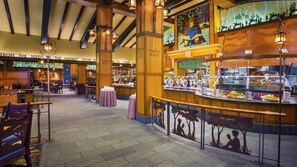 A restaurant with a central counter, tables, and chairs. - Anaheim | Romantic Disney Retreat | Pool + Spa (Anaheim)