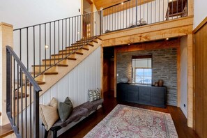 A staircase with a wooden finish and black railings leading to a second floor. - Altitude Vista-Front row Seat to Queenstown's Finest Views (Ben Lomond)