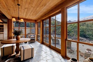 A spacious room with large windows, a wooden ceiling, and a stone floor. - Altitude Vista-Front row Seat to Queenstown's Finest Views (Ben Lomond)