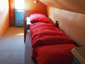 A narrow room with a single bed, a small blue cabinet, and a window with curtains. - Sunnebühl Appartement/Fewo, Bad, WC, 3 Schlafräume Ferienhaus 5.5-Zimmerwohnung by Interhome (Adelboden)
