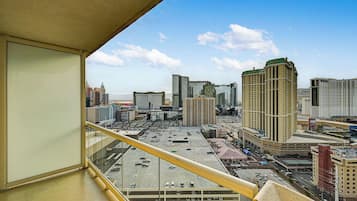 A cityscape with high-rise buildings, a parking lot, and a clear sky.