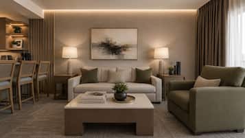 A modern living room with a sofa, armchair, coffee table, and lamps. There is a painting on the wall and a plant on the coffee table.