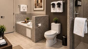 A modern bathroom with a shower, toilet, sink, and a glass-enclosed shower area.