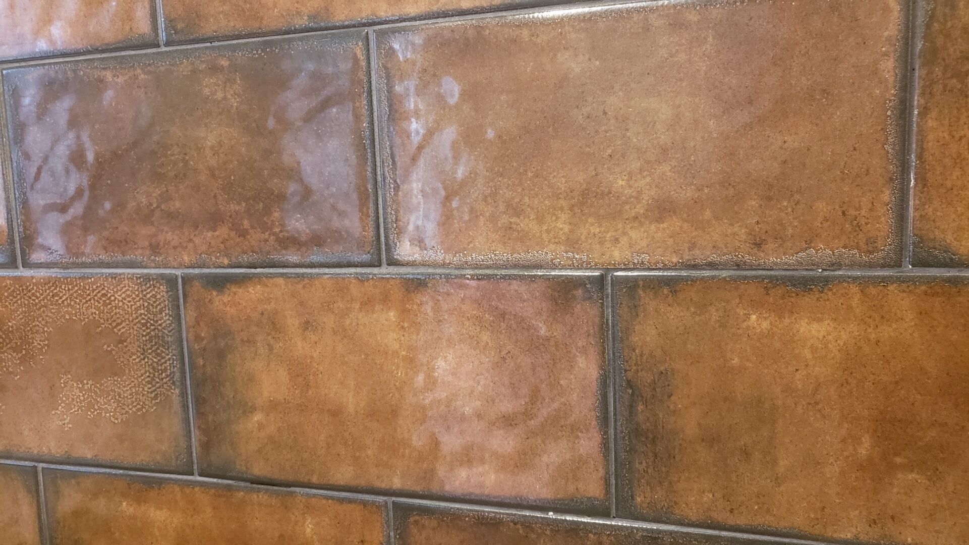 A close-up of a tiled wall with a consistent pattern.