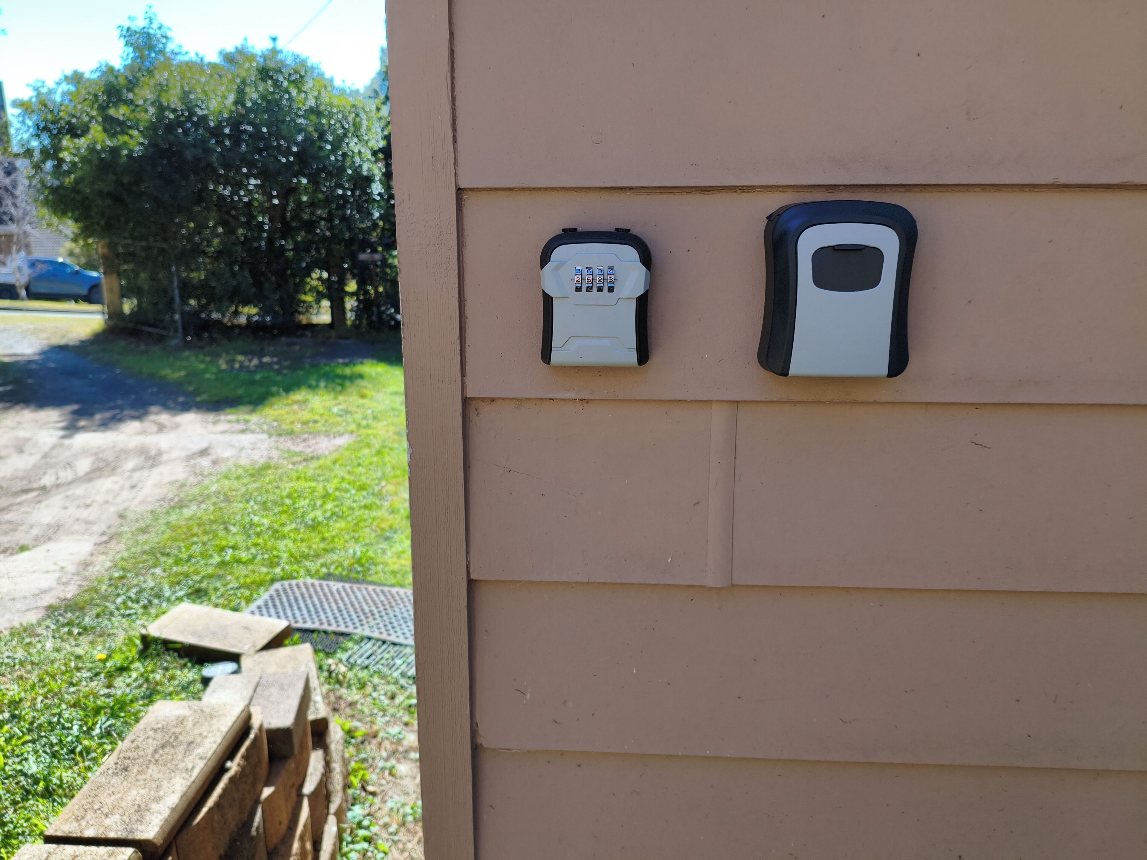 A wall-mounted intercom system and a mailbox.