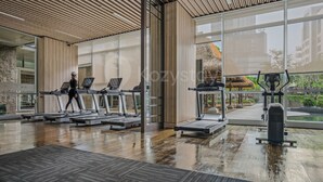 A gym with treadmills, a stationary bike, and a rowing machine. - Ardana by Kozystay - Tunjungan (Surabaya)