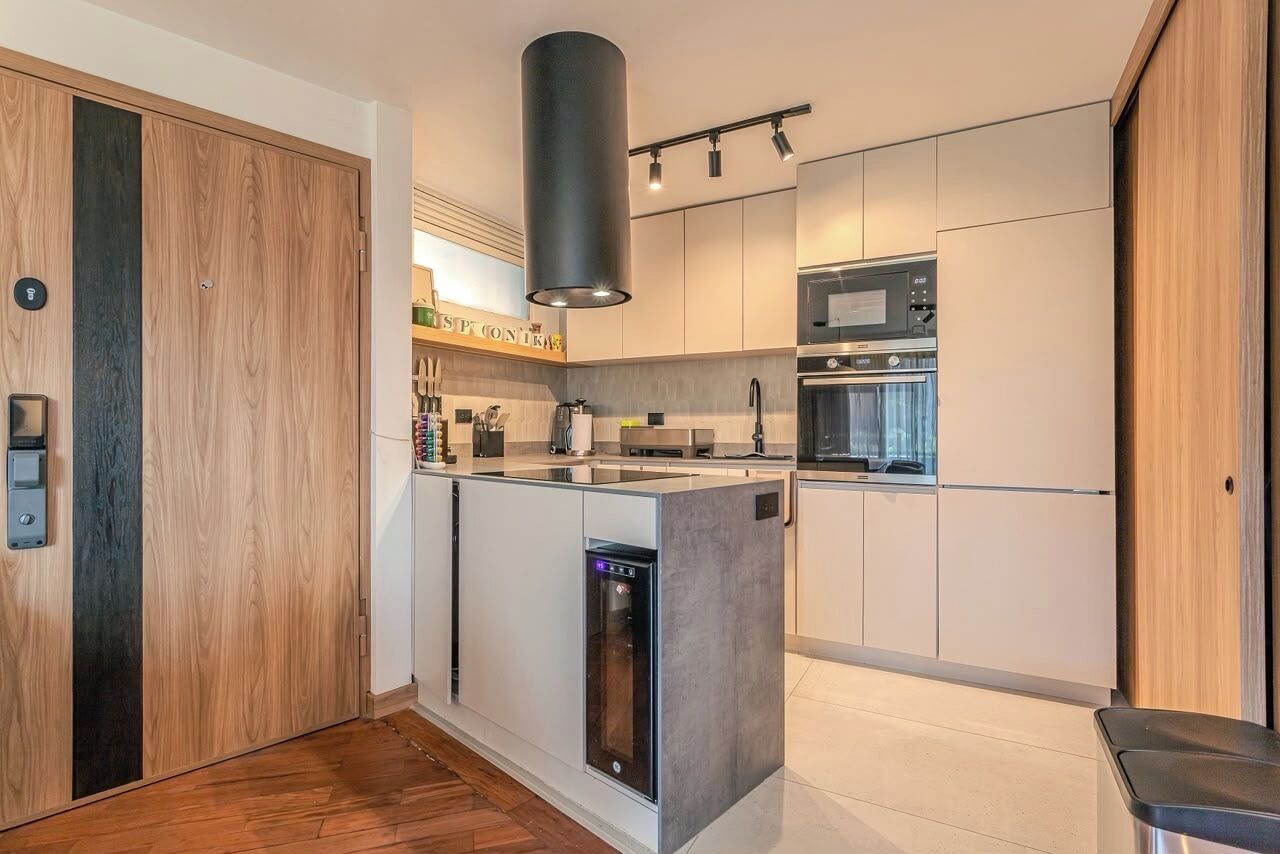 A modern kitchen with a built-in dishwasher, a microwave, and a stove.