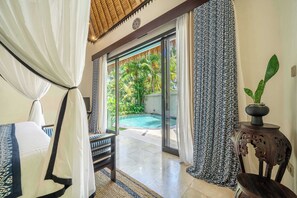 A room with a bed, a view of a swimming pool, and a door leading outside. - Boho 2BR w Pool+Patio+Garden in Peaceful Ubud (Gianyar Regency)