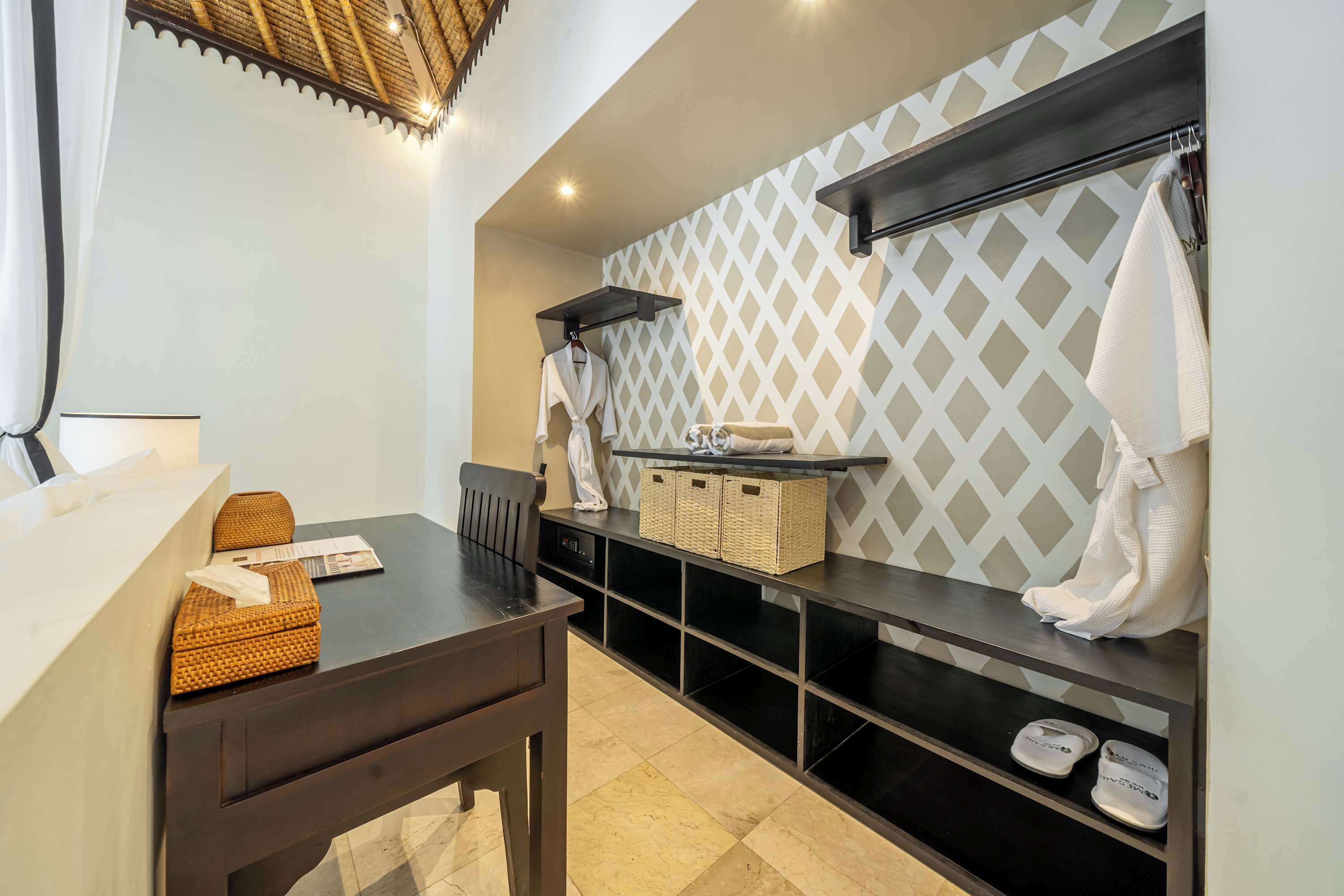 A modern bathroom with a vanity, a towel rack, and a shelf with toiletries.