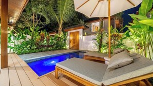 A poolside area with lounge chairs and a wooden deck. - Designer 2BR Villa in Serene Ubud w Pool & Garden (Gianyar Regency)