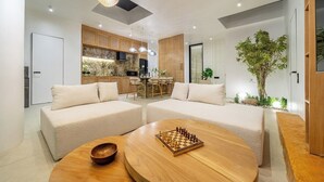A modern living room with two sofas, a coffee table, and a chessboard. - New Tropical 3BR Villa+Private Pool+Best Location (South Kuta)
