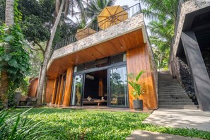 A modern two-story building with a wooden facade, large glass windows, and a stone staircase. - Jungle 9BR Ubud Paradise with spa! (Ubud)