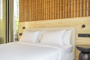 A modern hotel room with a large bed, a wooden headboard, and a small round table. - Brand New Private 2BR Villa+Huge Pool+Beach Access (South Kuta)