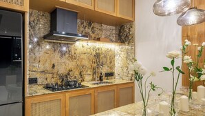 Una cucina moderna con un piano di lavoro in granito, elettrodomestici in acciaio inossidabile e mobili in legno.