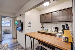 Stylish kitchen with wood accents, granite counters, and full cookware setup—complete with a breakfast bar perfect for casual dining or morning coffee. - Private-Entry Apt Near Med Center + Parking (Milwaukee)