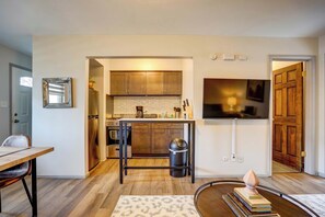 A compact kitchen with wooden cabinets, a stainless steel refrigerator, and a built-in oven. - Pet-Friendly Apt Near Med Center + Parking (Milwaukee)