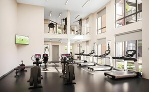Spacious two-level fitness center with floor-to-ceiling windows, cardio machines, strength equipment, and TVs—perfect for energizing workouts with plenty of natural light. - Modern Apt with Pool, Parking & Pet Wash (Madison)