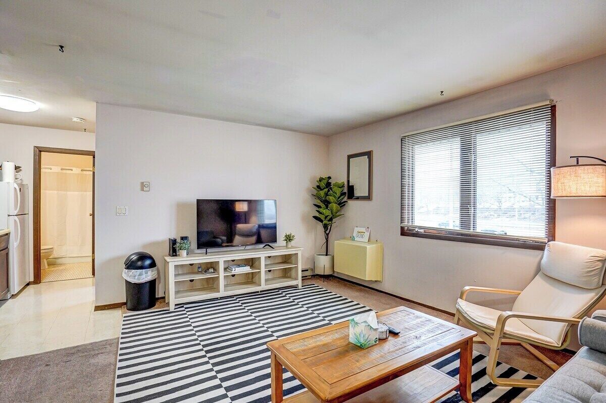 Living room with Roku Smart TV, couch and chair. You can see the VA hospital out the window!