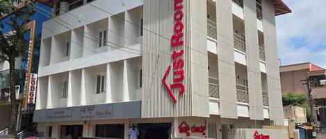 A multi-story building with a prominent red sign indicating 'Lodge Rooms'.