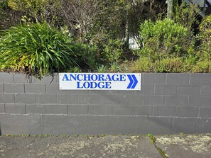 A sign for Anchorage Lodge with a directional arrow.