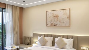 A modern hotel bedroom with a large bed, bedside tables, a nightstand, and a window with curtains. - ALAYA STAYS SAVIAN Suites (Chikkajala)