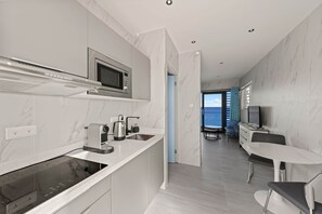 A modern kitchen with a built-in microwave, kettle, and coffee machine. - LagunBay  Oceanfront Pearle 2p (Lagun)