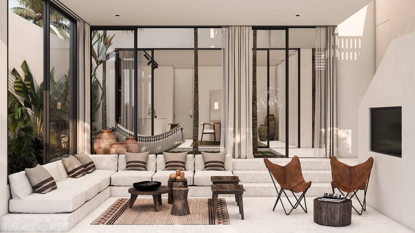 Una sala de estar moderna con sofá, mesa de centro y sillas, ventanas amplias y vista a una escalera.