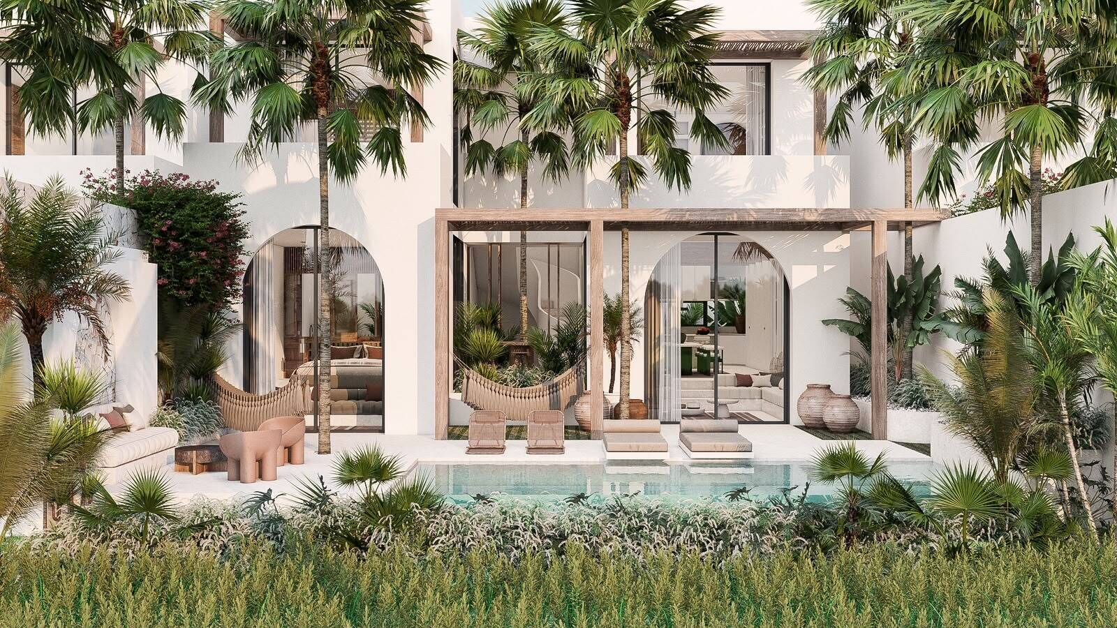 Une maison moderne dotée d’une piscine, d’un espace salon extérieur et de plantes tropicales.