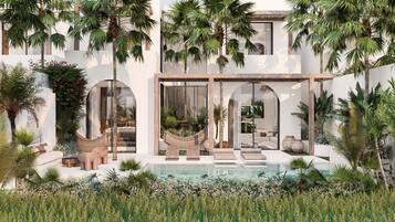 Une maison moderne dotée d’une piscine, d’un espace salon extérieur et de plantes tropicales.