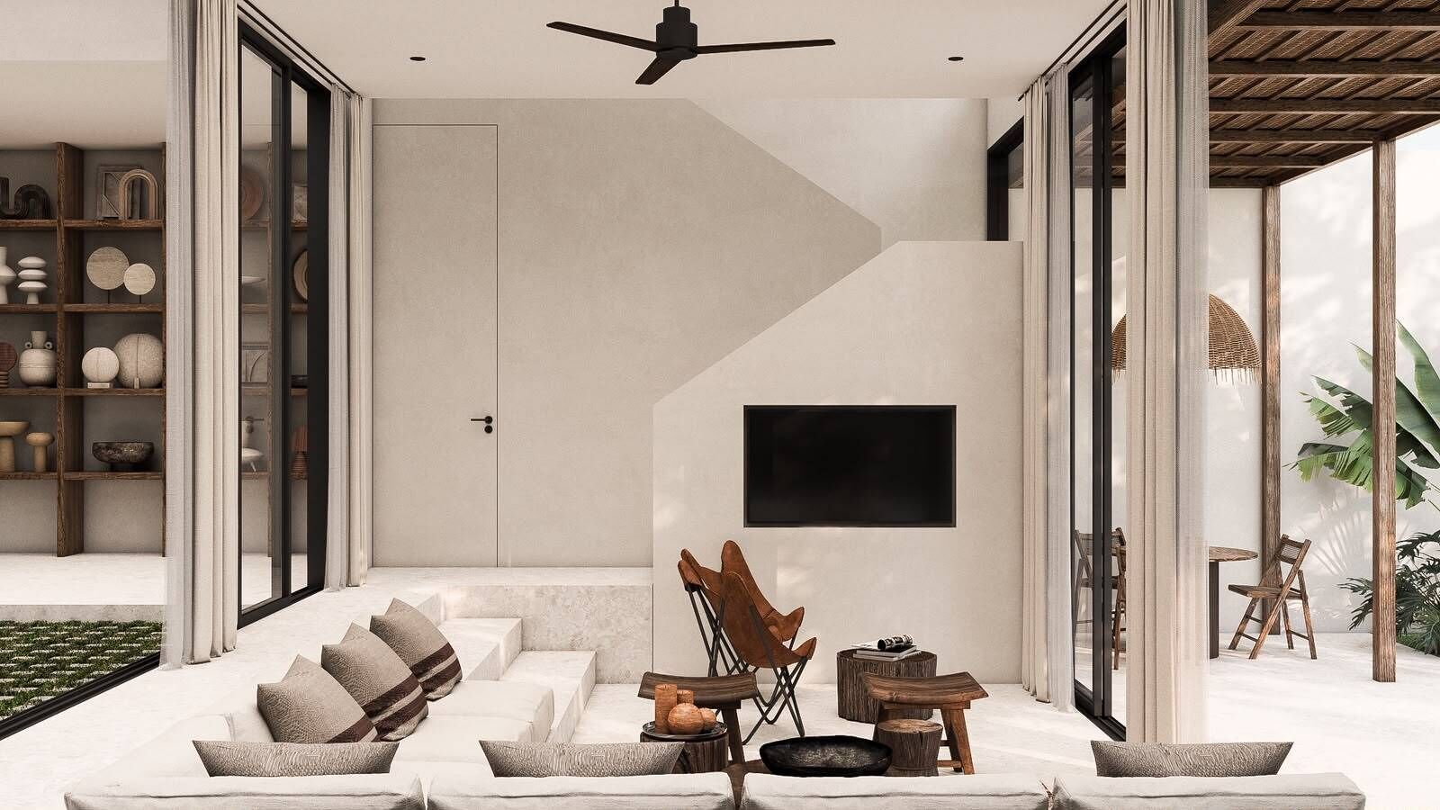 A modern living room with a sofa, chairs, a flat-screen TV, and a staircase leading to another level.