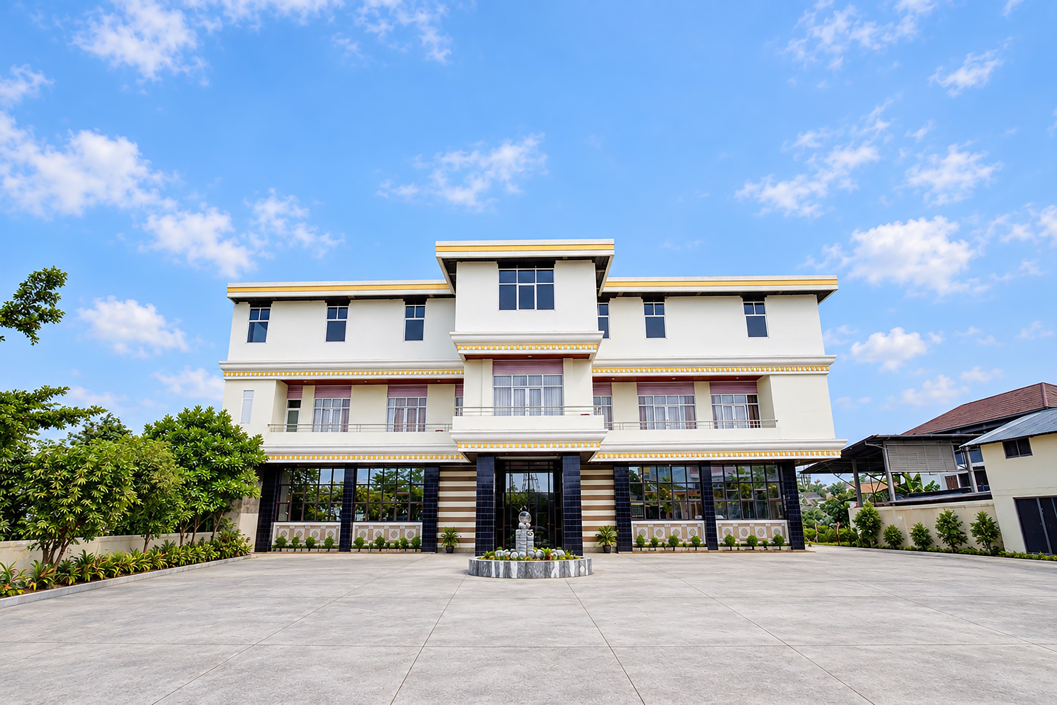 A multi-story building with a symmetrical facade, large windows, and a central entrance.