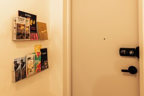 A wall with a door and a door lock.
