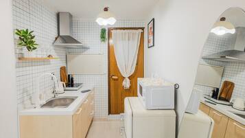 Microwave, cookware/dishes/utensils, spices, dining table