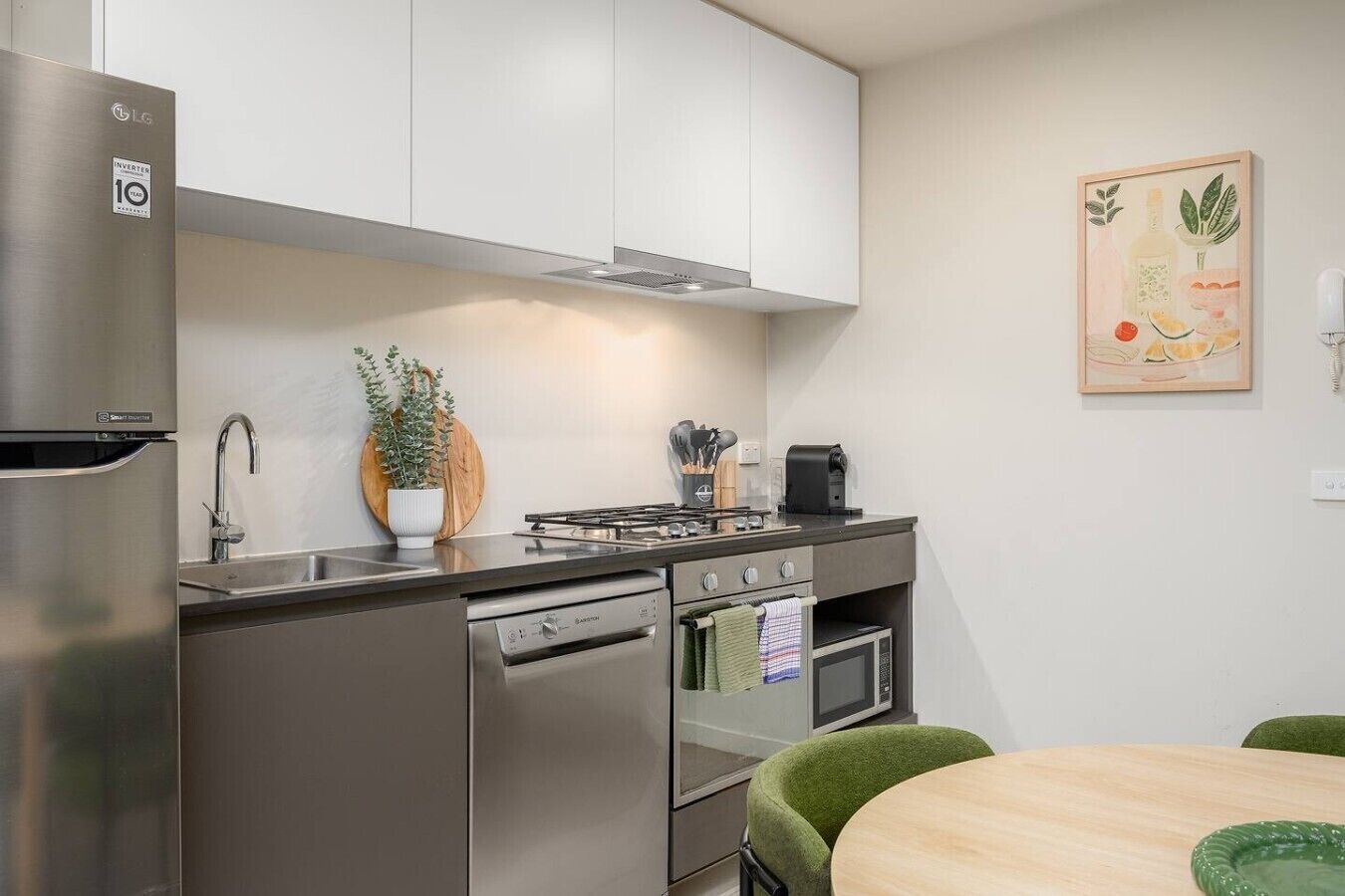 A modern kitchen with stainless steel appliances, a built-in oven, and a microwave.