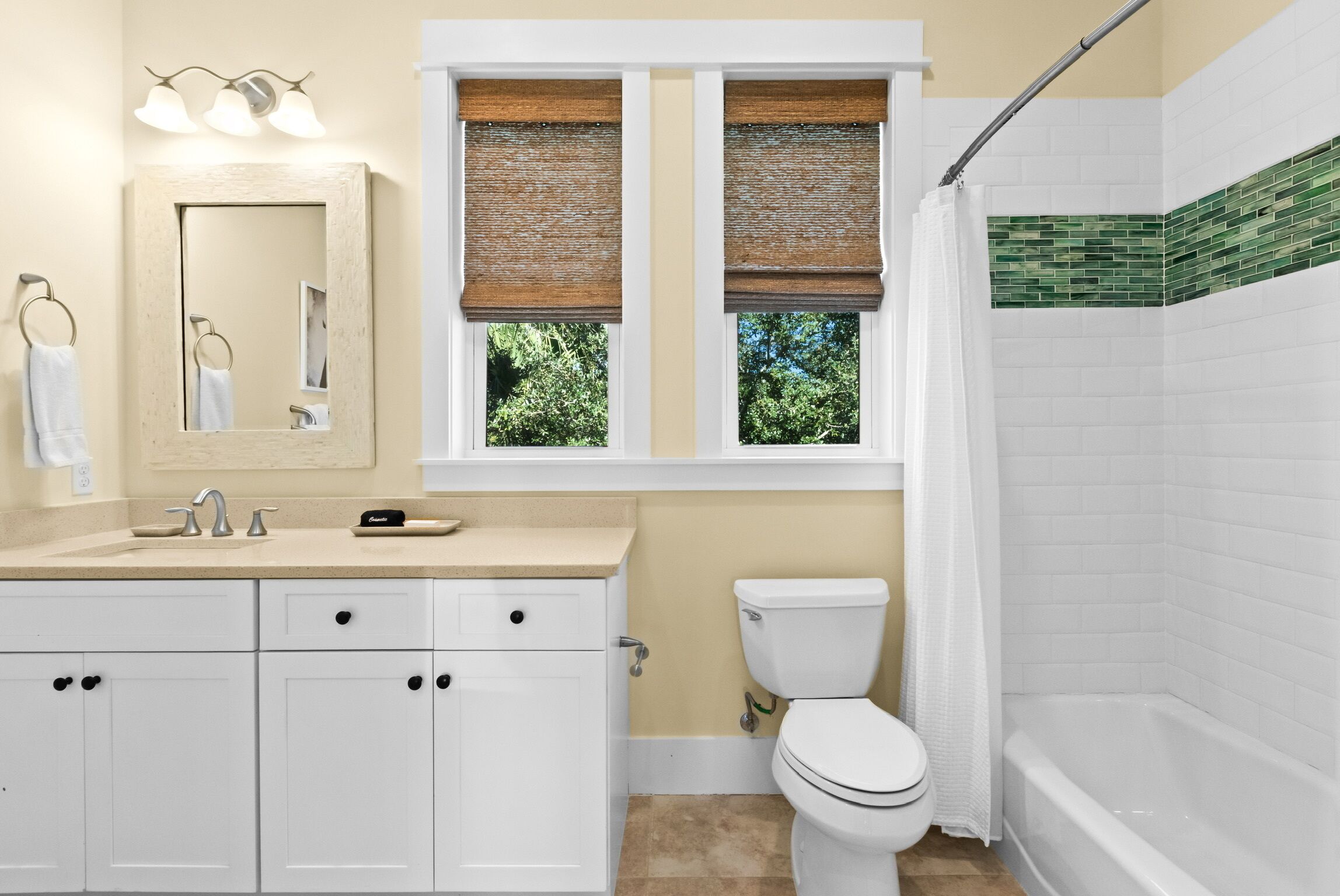 A bathroom with a toilet, sink, and shower area.