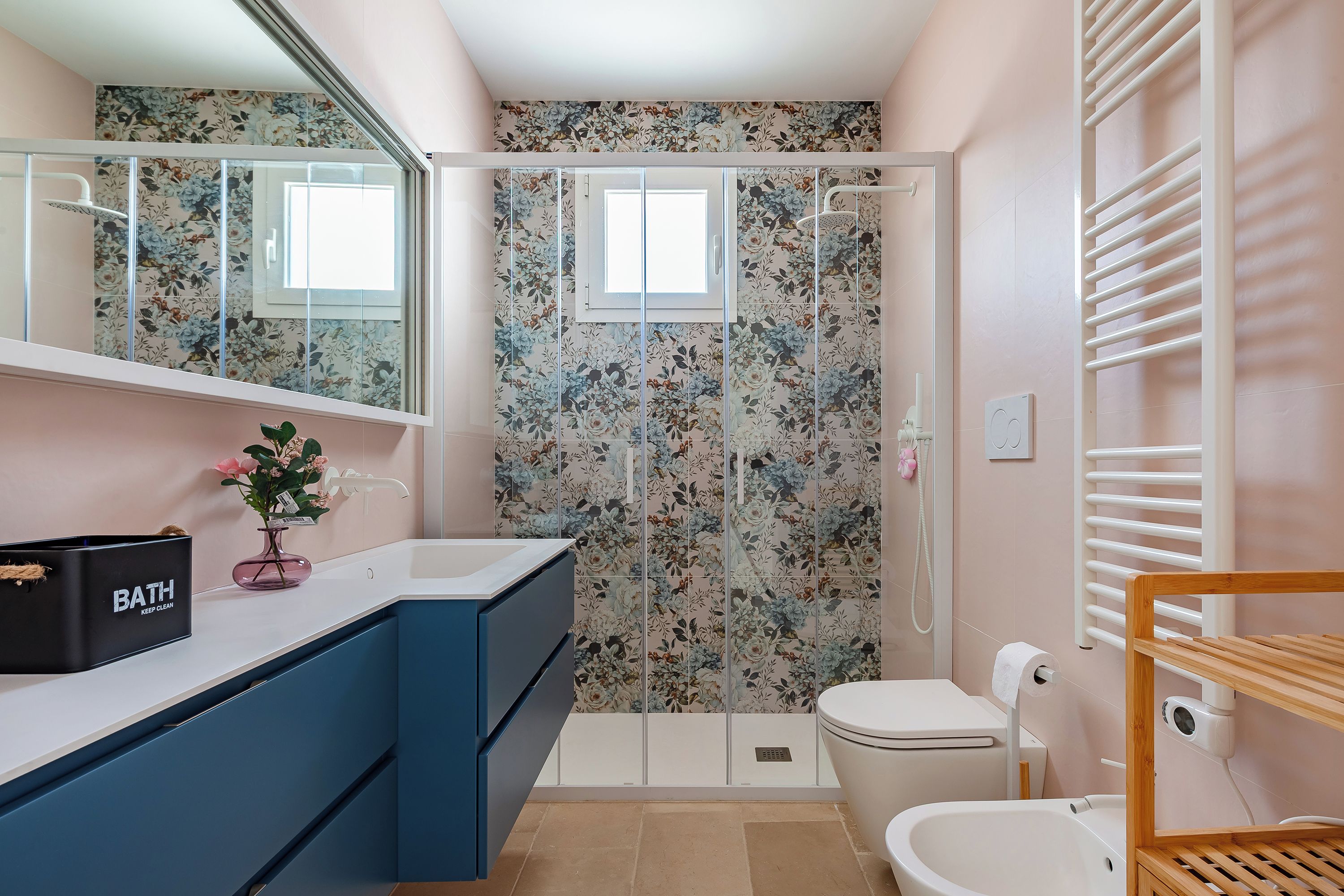 A modern bathroom with a shower, toilet, and sink.