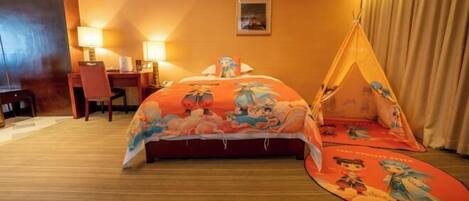 A hotel room with a bed, a desk, a chair, a lamp, and a tent-like structure.