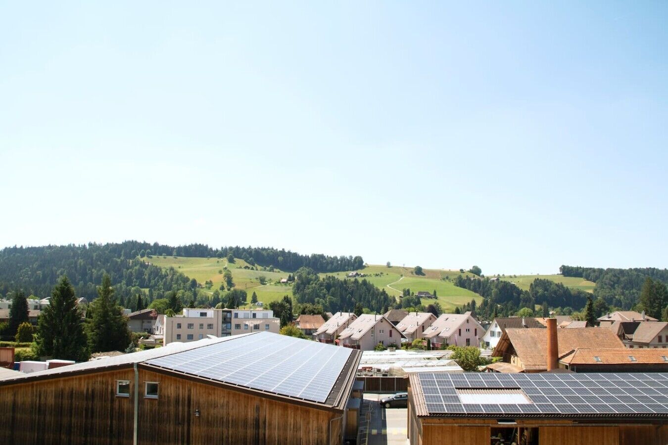 A residential area with houses and solar panels on rooftops.