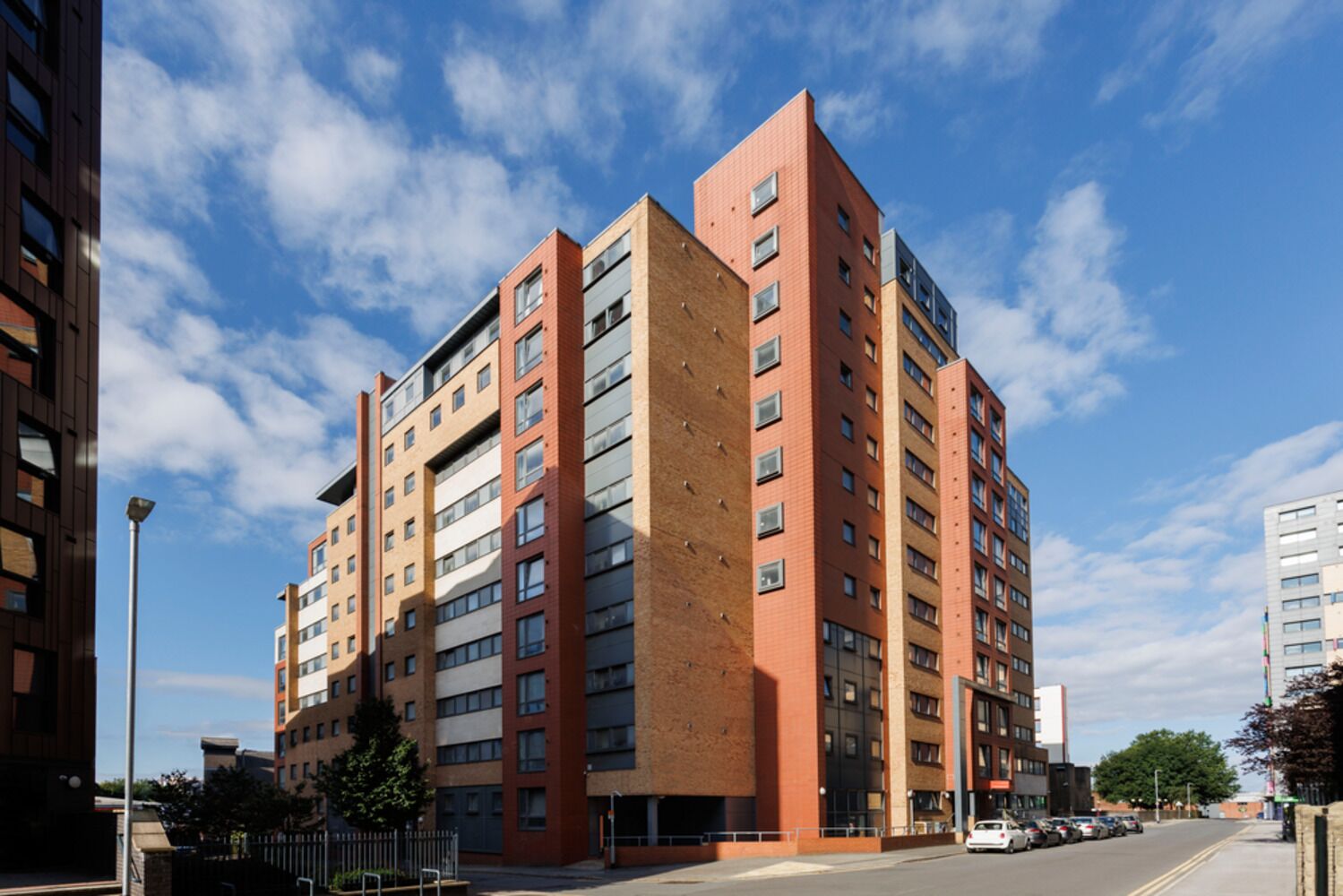 A multi-story residential building with a brick facade and multiple windows.